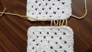 And work back and forth (as if you are lacing your shoes!) and when you reach the half way point, you will take both ends of your yarn strand, on left and right side, and pull tightly all strands together until closed.